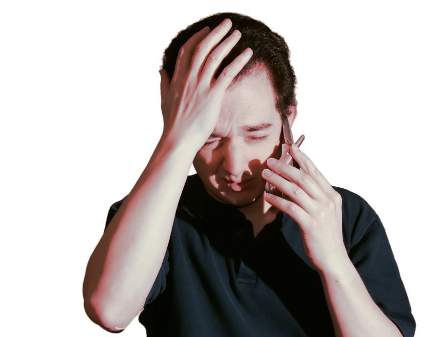 man full of emotion and holding his head