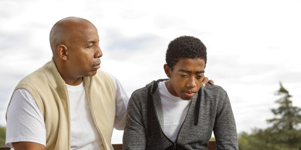 man in fifties mentoring teenage boy on trust