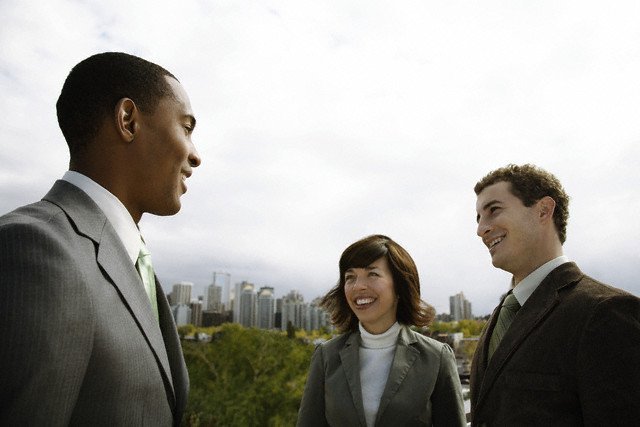 man in suit talking to two people that he intends to convert to followers