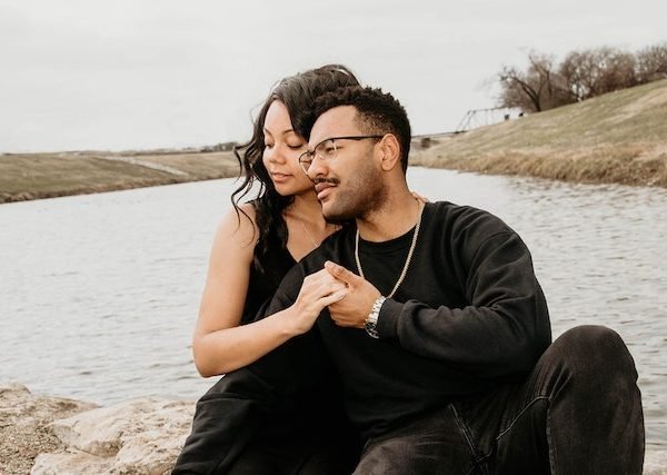 couple enjoying intimacy beside lake