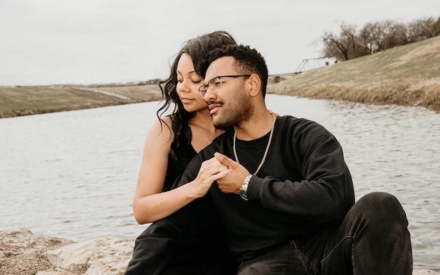 couple enjoying intimacy beside lake
