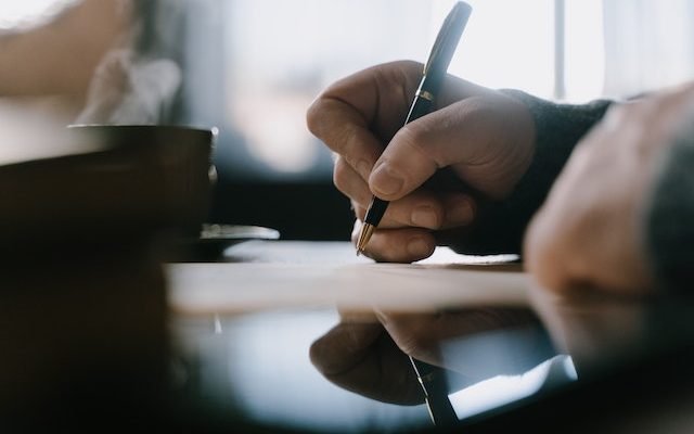man writing his performance assessment