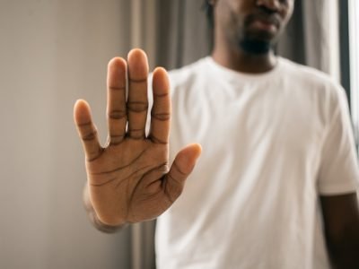 man raising his hand to say no