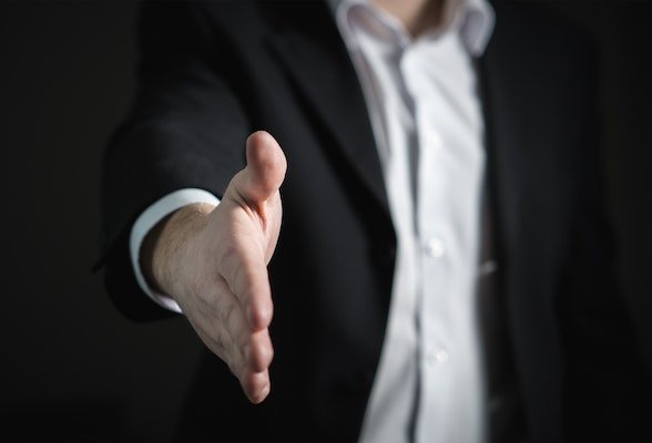 man extending his hand for a handshake out of trust