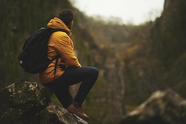 man on rock thinking of improving his earning ability