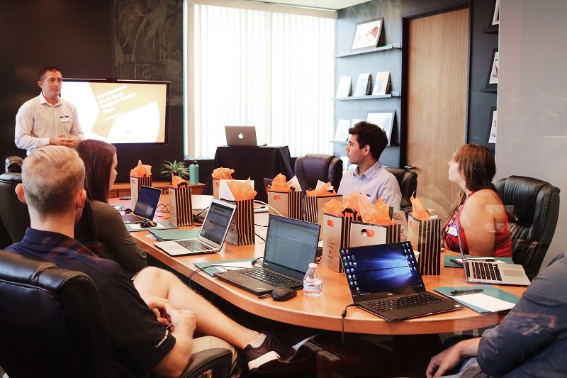 business manager improves his brand as he holds meeting with employees