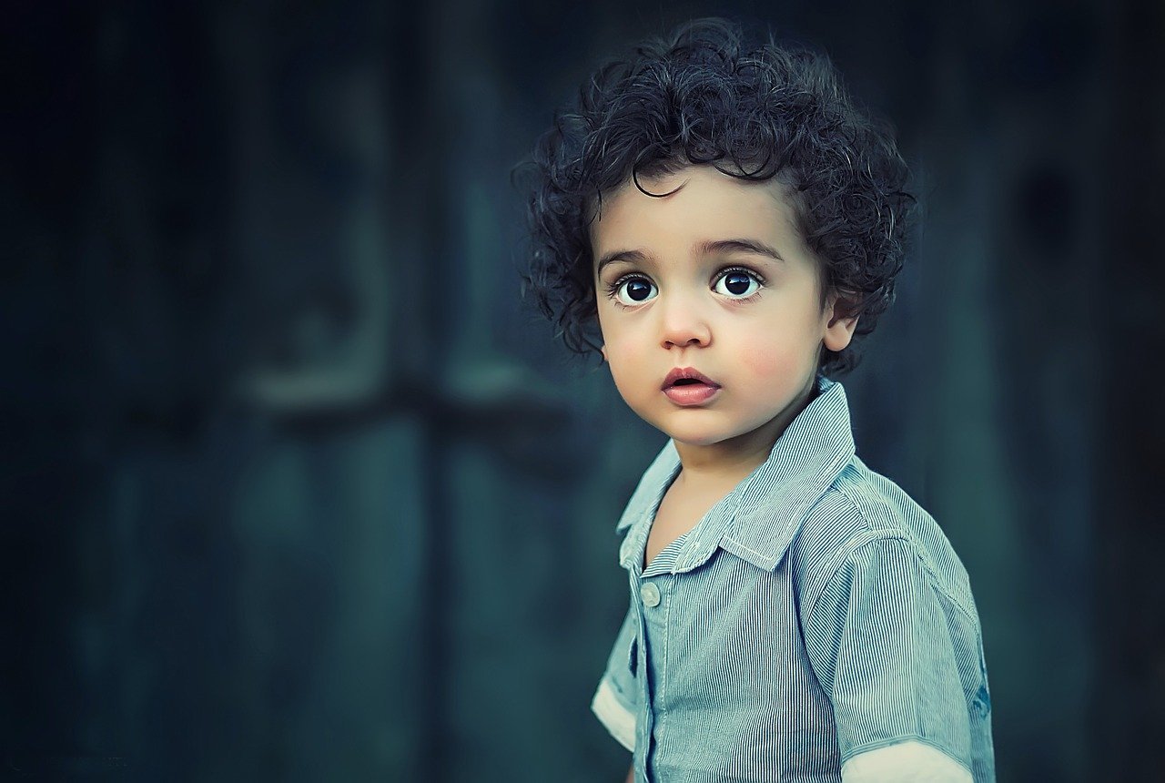 cute boy whose parents are raising beautifully