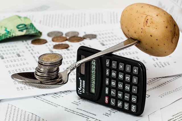 a good budget like balancing coins and potato on spoon