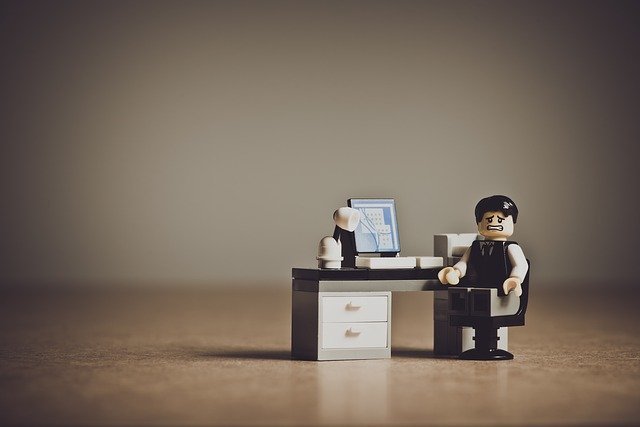lego figure of tense new employee who hasn't settled down in his workplace