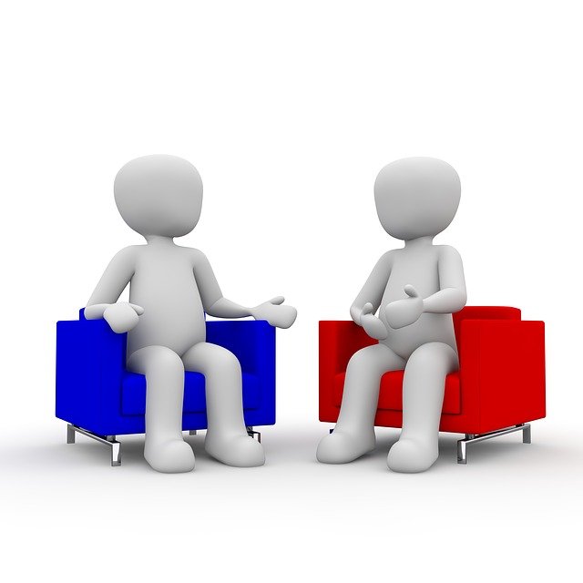 two human figures in conversation
