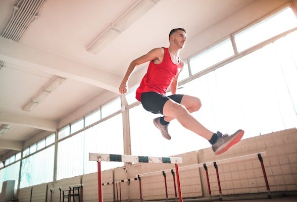 hurdle race runner overcoming obstacles