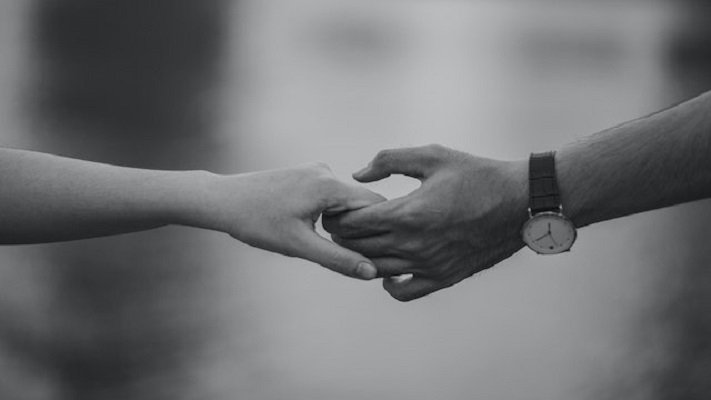 couple holding hands in marital satisfaction