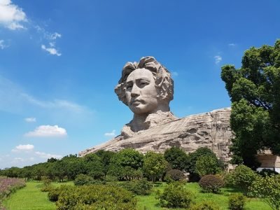 decision making - giant stone sculpture of giant beside green field