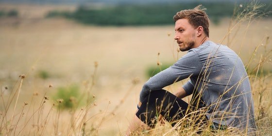 man sitting in field without toxic negative people