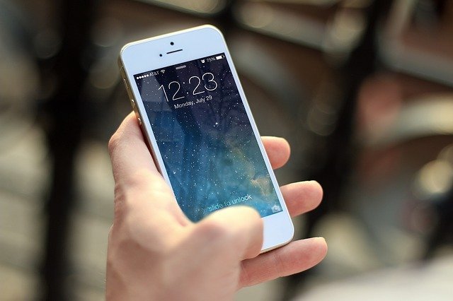 busy person with phone responding to email