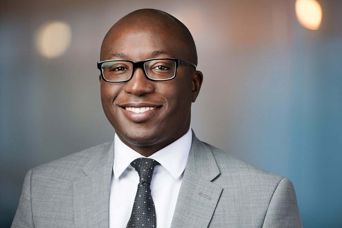 man in suit wearing glasses and a smile who possesses talent