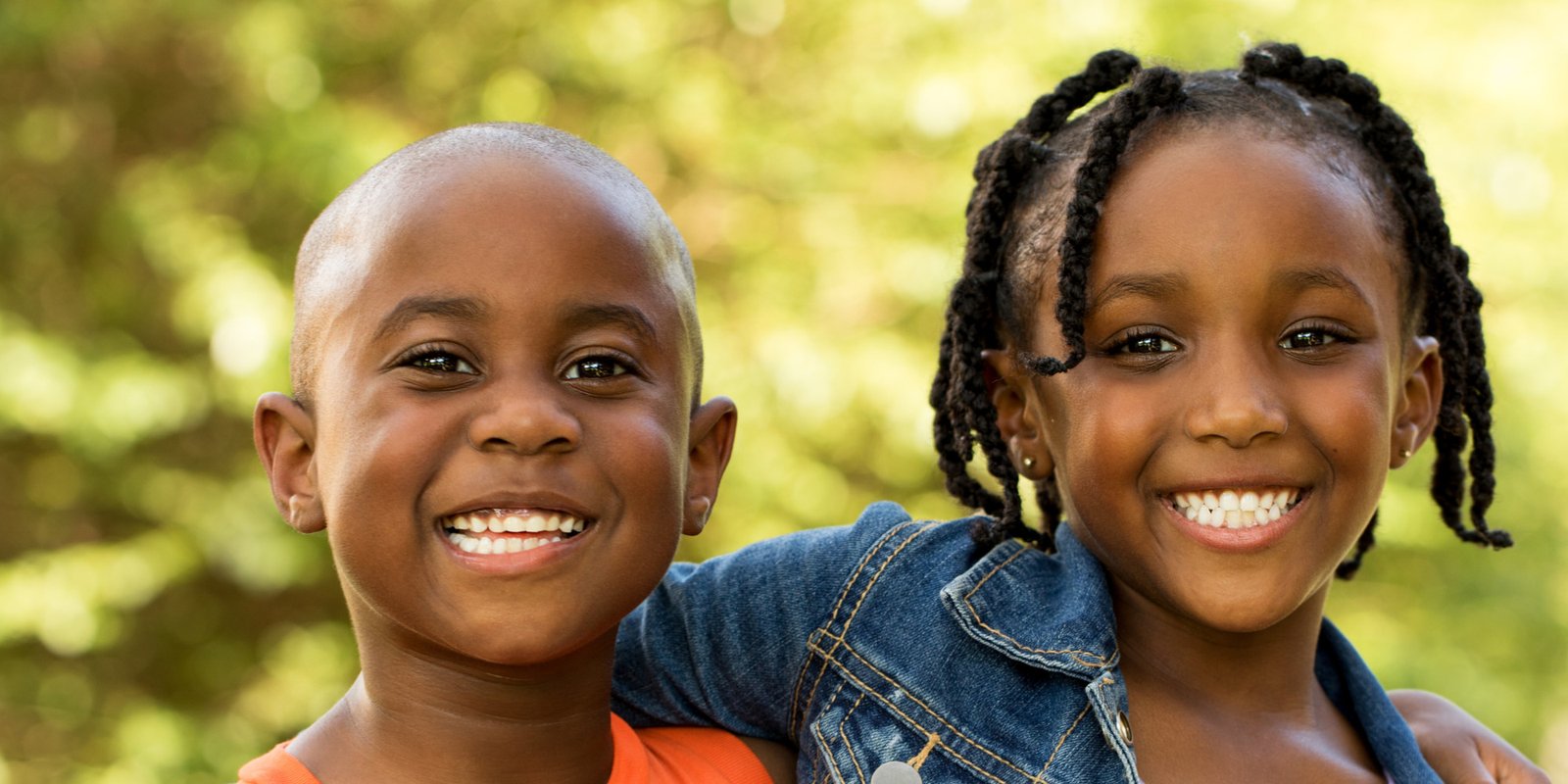 little boy child and his sister grinning