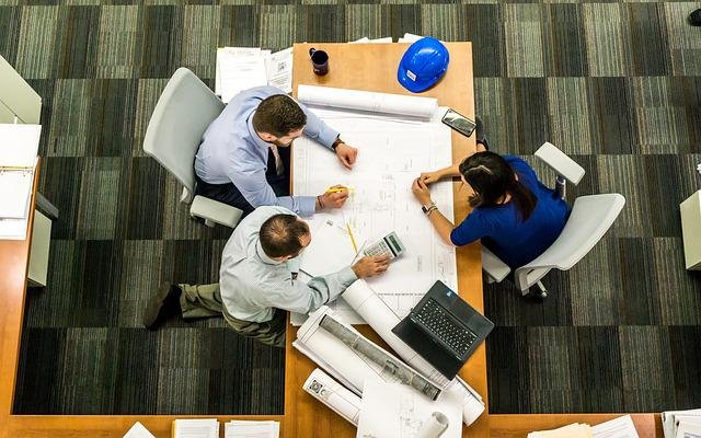 two men and a woman having effective meeting