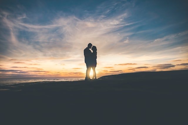 silhouette of a better husband hugging his wife closely