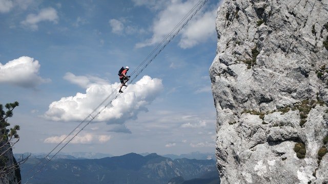 man making difficult mountain climb looking for opportunities