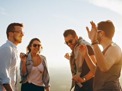 man laughing with his inner circle