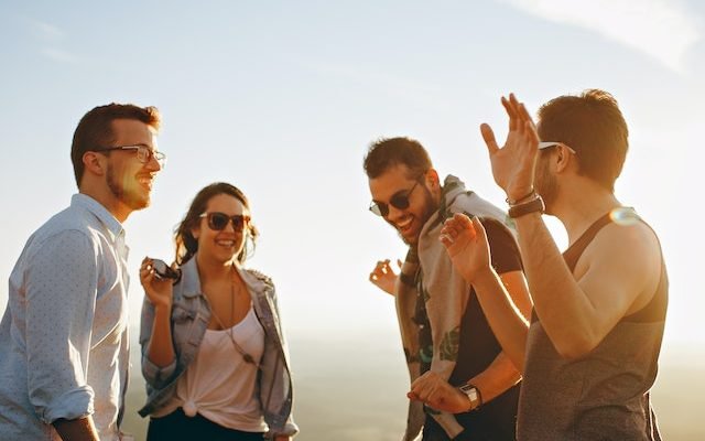 man laughing with his inner circle